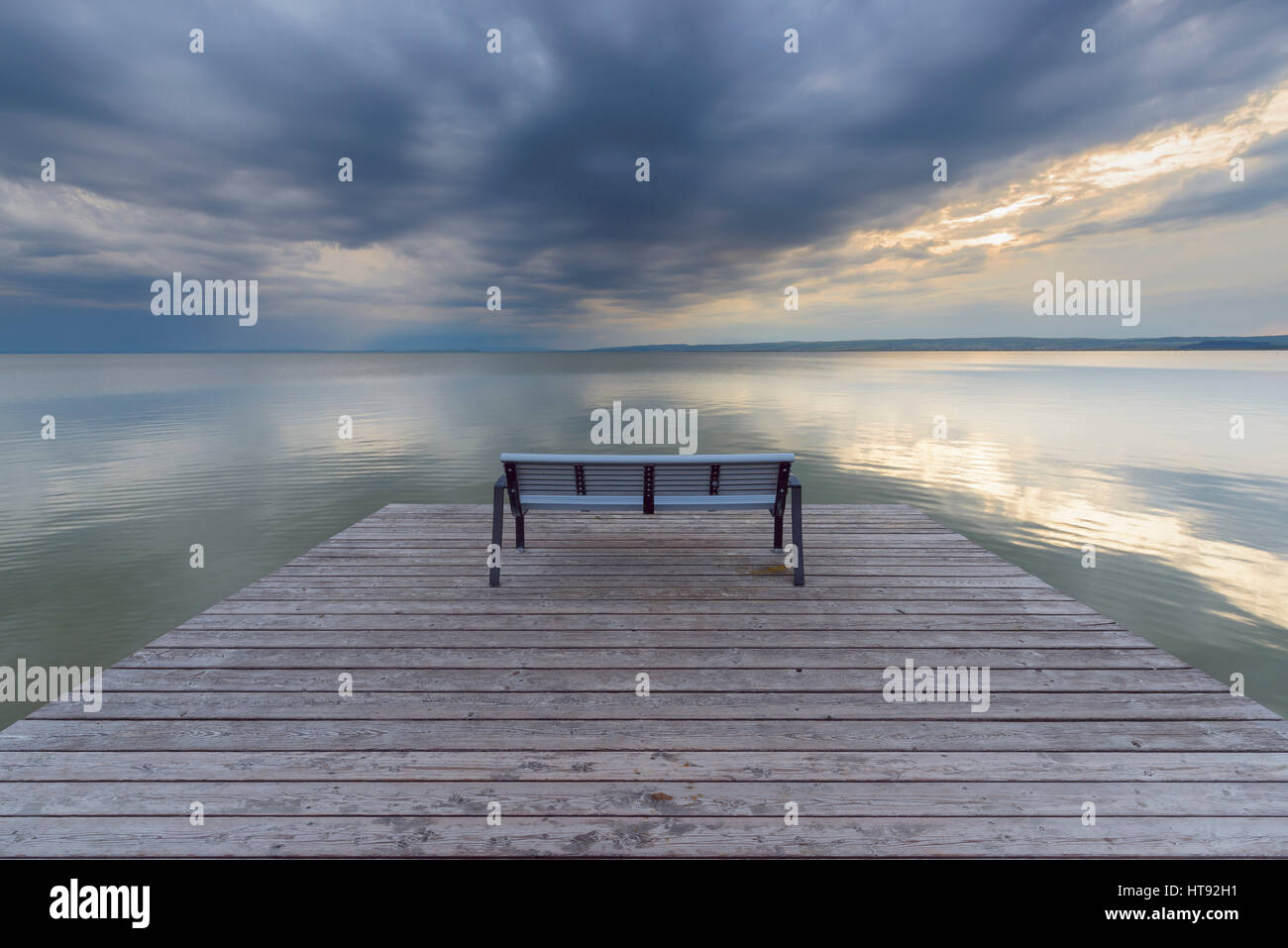 Bench on Wooden Jetty at Sunset at Weiden, Lake Neusiedl, Burgenland, Austria Stock Photo