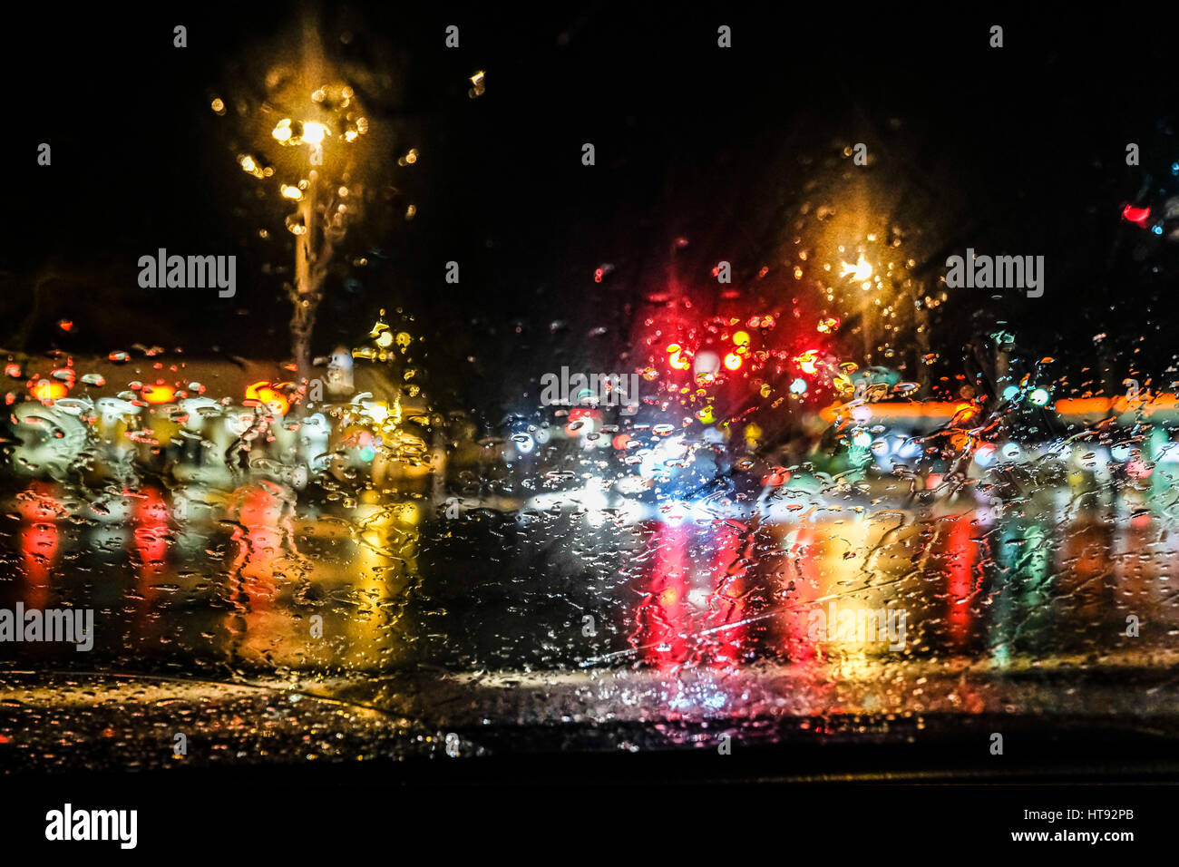 Night Traffic Lights Seen Through a Rain Blurred Car Windshield Stock