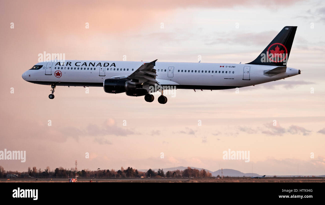 Air Canada plane airplane Airbus A321 (A321-200) narrow-body jetliner airborne painted in the company's new livery landing Vancouver airport Stock Photo