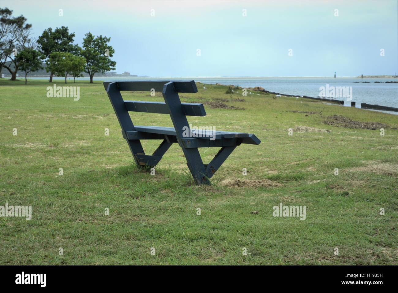 Empty bench water front. Empty bench sea facing, Empty bench river front, Empty bench in park in Australia. Stock Photo