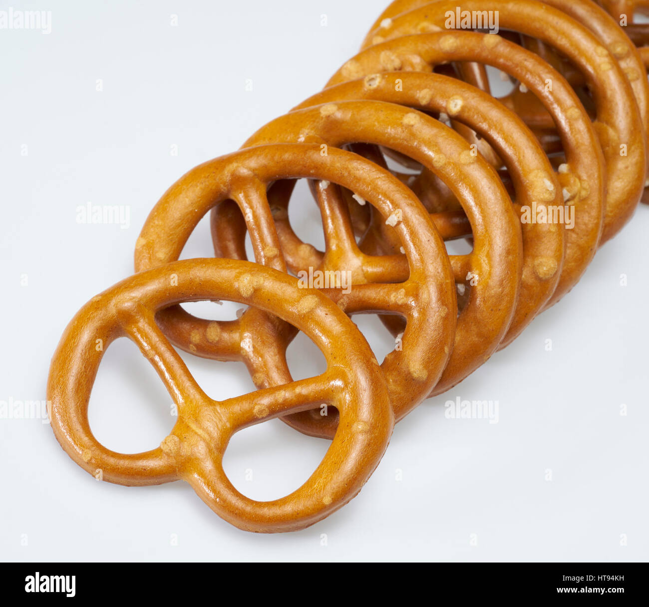some lye pretzels in a row in light back Stock Photo Alamy