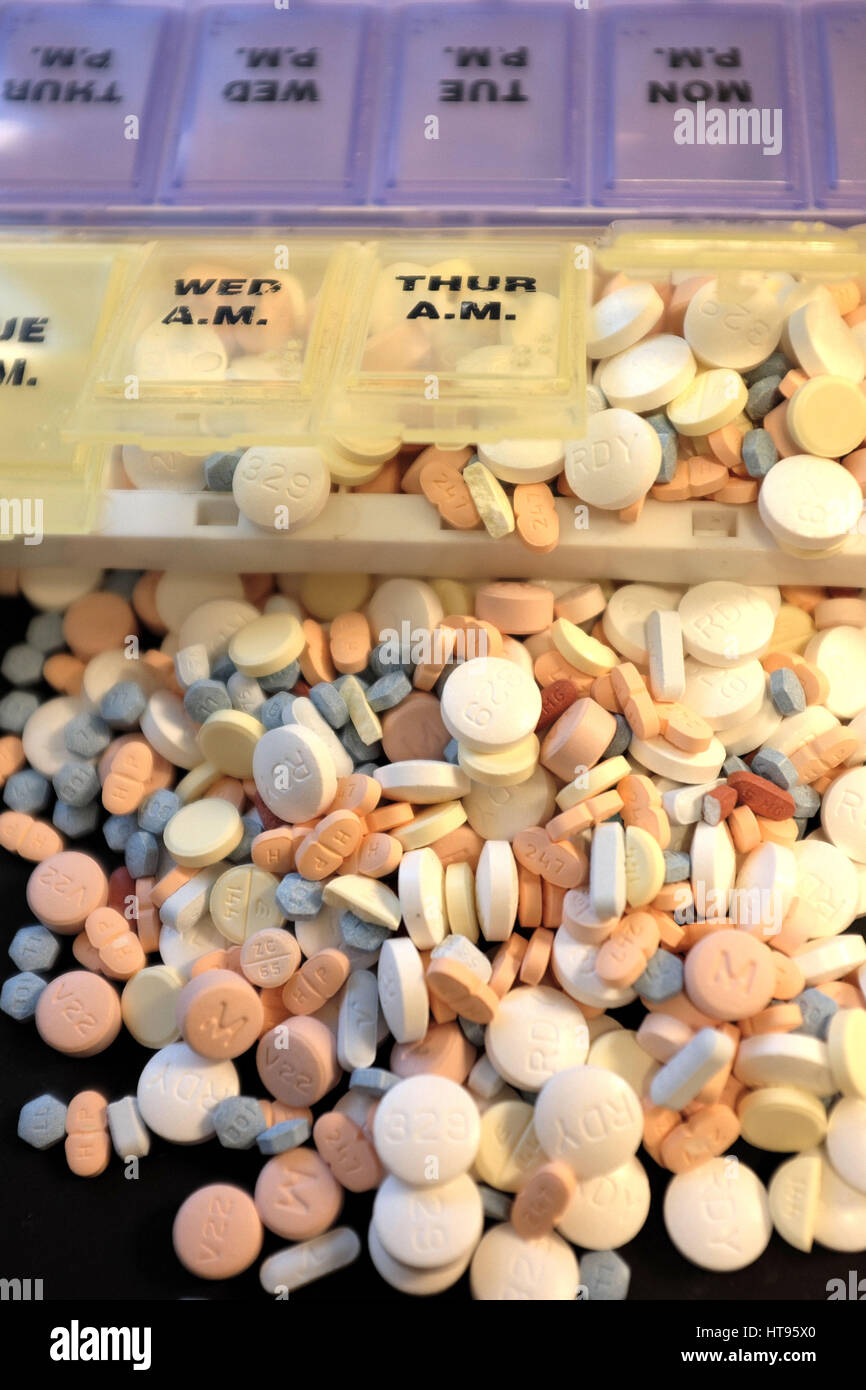 Pill box overflowing with prescription drugs Stock Photo