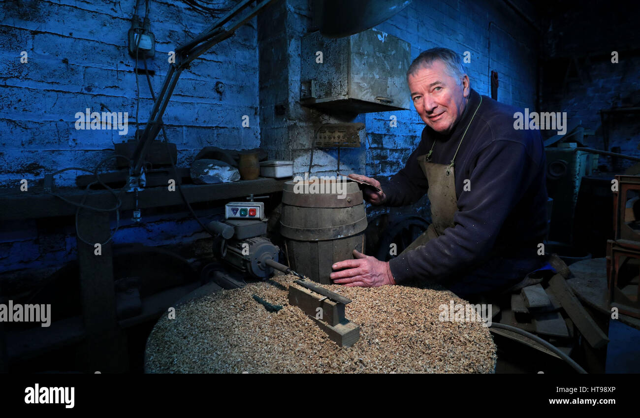 Les Skinner, 72, who is the oldest cooper in England, at his cooperage in Bootle, Liverpool. Stock Photo