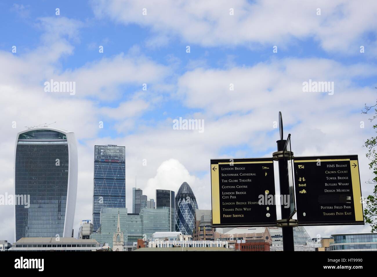 THAMES SOUTHBANK LONDON  ENGLAND 2 May  2015:  Looking towards Canary Wharf with sign in foreground Stock Photo