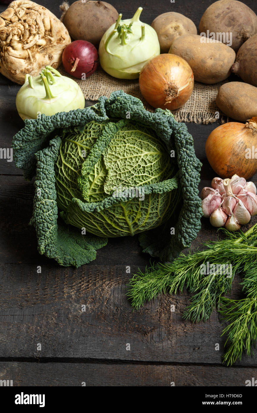 Spring vegetables on a dark background: Savoy cabbage, cauliflower ...