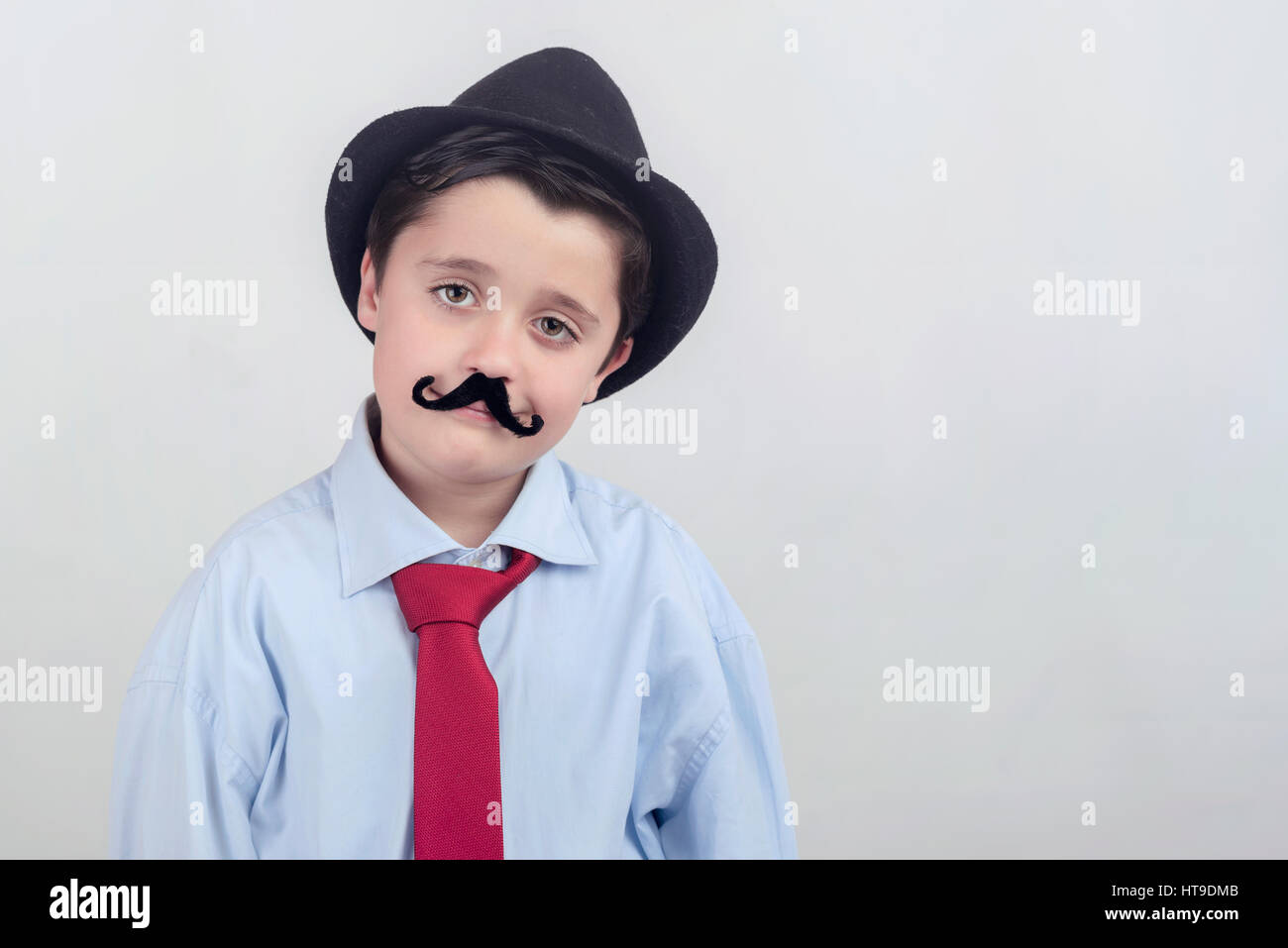 Funny boy with fake mustache and tie Stock Photo