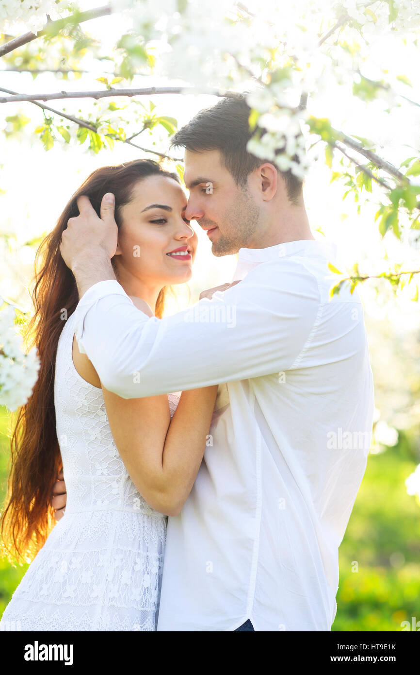 Young couple in love kissing and hugging in nature Stock Photo - Alamy