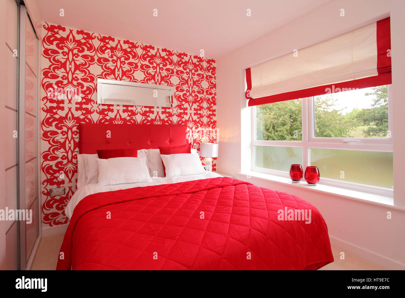 Home interior, bedroom, bright red, decor, bed spread, padded headboard, feature wall, Stock Photo