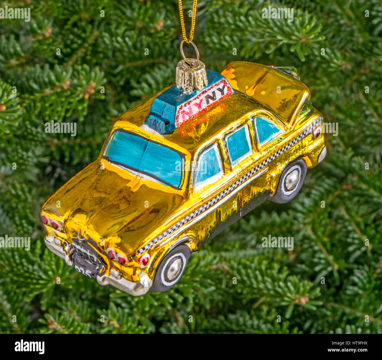 Christmas bauble hanging from a tree in the shape of a New York Yellow Taxi Stock Photo
