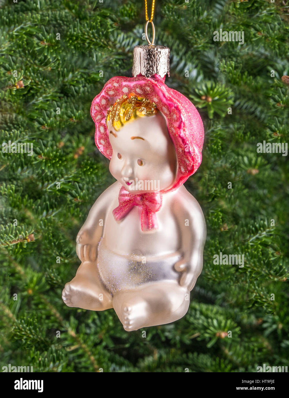 Christmas bauble hanging from a tree in the shape of a Cute Baby Stock Photo