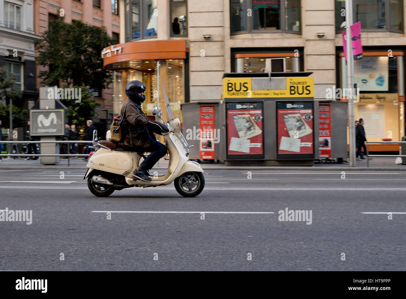 One person riding a beige Vespa scooter motorcycle in Madrid city (Spain) 2017. Stock Photo