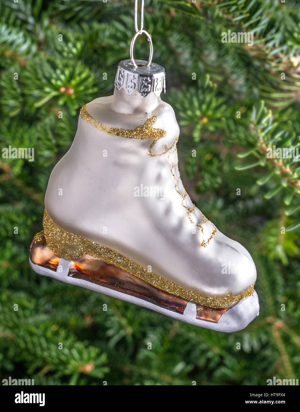 Christmas bauble hanging from a tree in the shape of a White Ice Skating Boot Stock Photo
