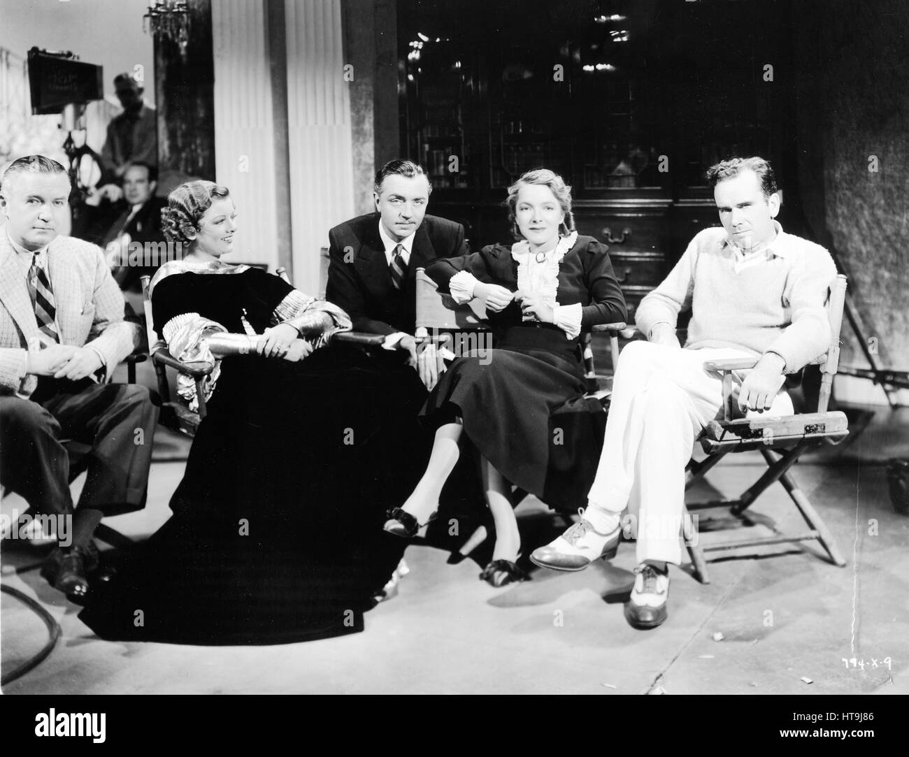 'It's a constellation of stars...with Helen Hayes visiting Myrna Loy and William Powell on the 'Evelyn Prentice' set at the Metro-Goldwyn-Mayer studios...On the sidelines are, left, Producer John Considine, and right, Director William K. Howard. The diminutive Miss Hayes recently completed work in 'What Every Woman Knows,' at that studio.' Stock Photo
