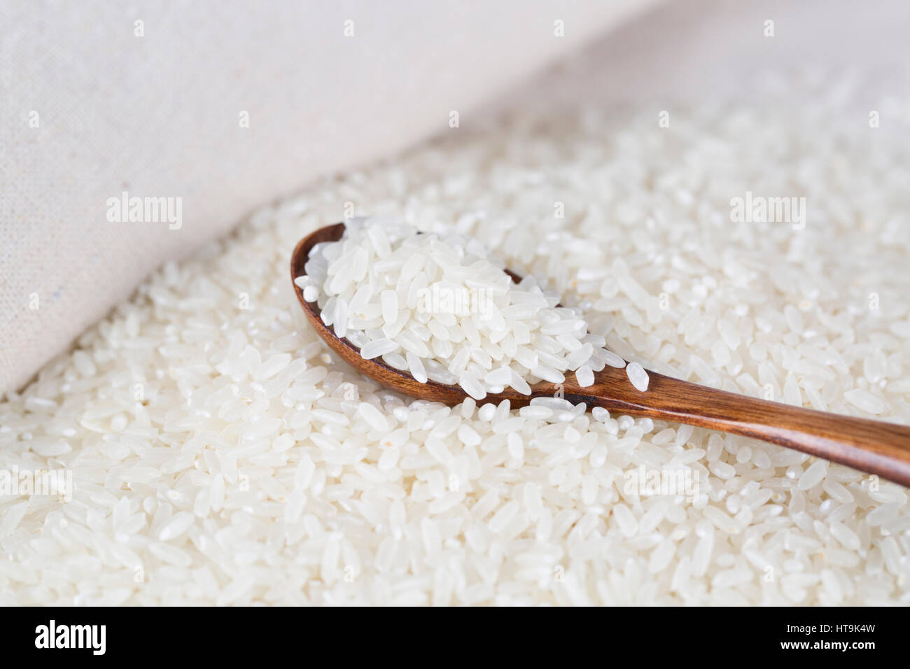 Rice grains closeup on the wooden spoon Stock Photo - Alamy