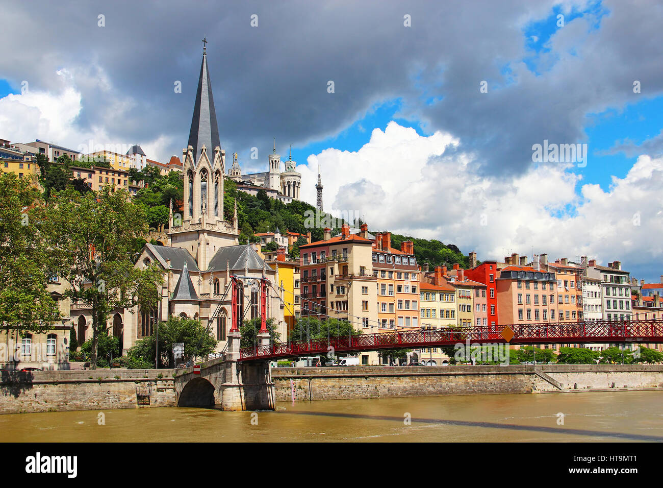 St. Georges church and St. Georges bridge over Saone river, with Basilica of Notre-Dame de Fourviere on the background, Lyon, France Stock Photo
