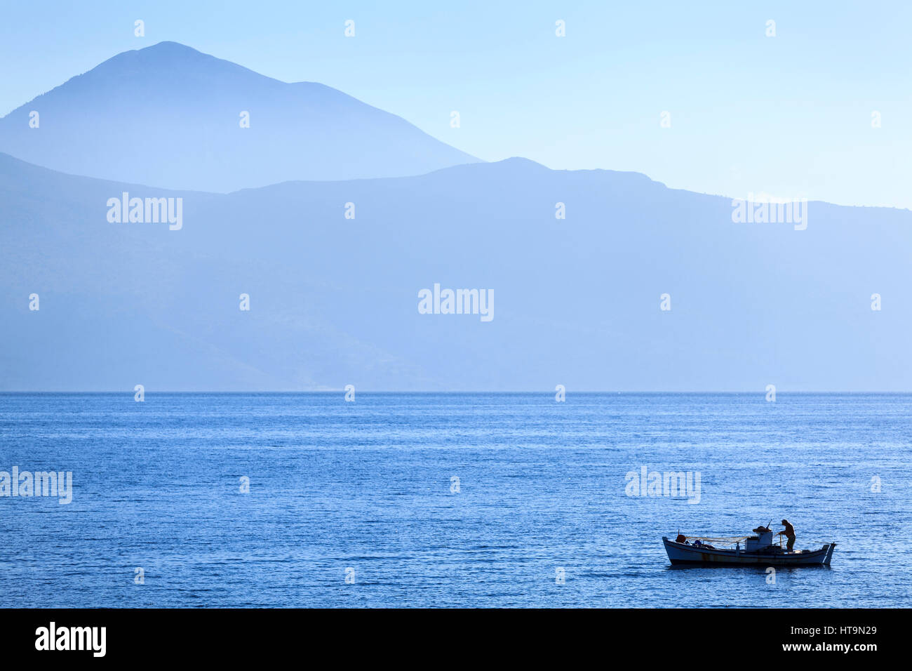 Fisherman on traditional boat, Meganissi, Greece Stock Photo