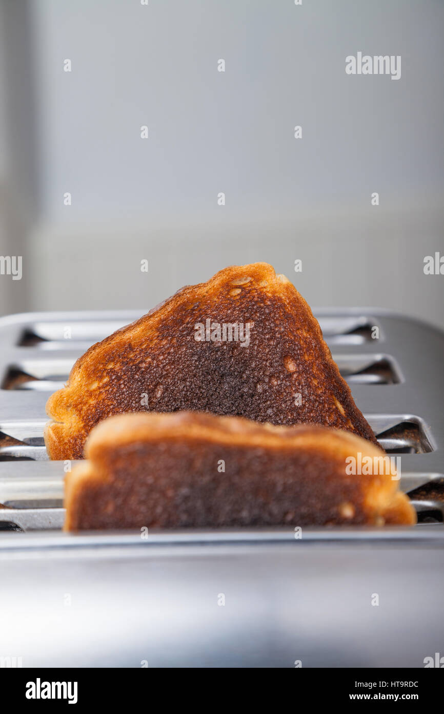 Two slices of burnt toast in a metal toaster Stock Photo Alamy