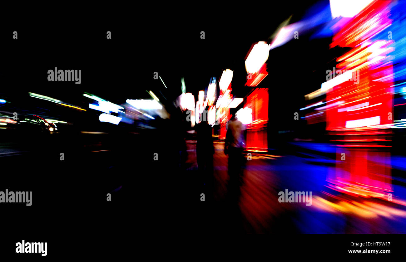 People walking on street with motion, blur and zoom effects. Negative space. Stock Photo
