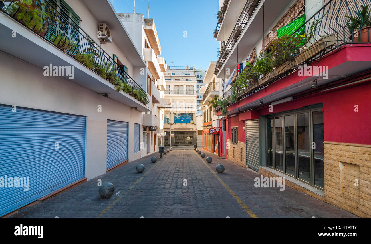 Vacant & shaded, empty alleyway on otherwise bright sunlit day in Sant Antoni De Portmany. Ibiza in quiet off-season in the afternoon. Stock Photo
