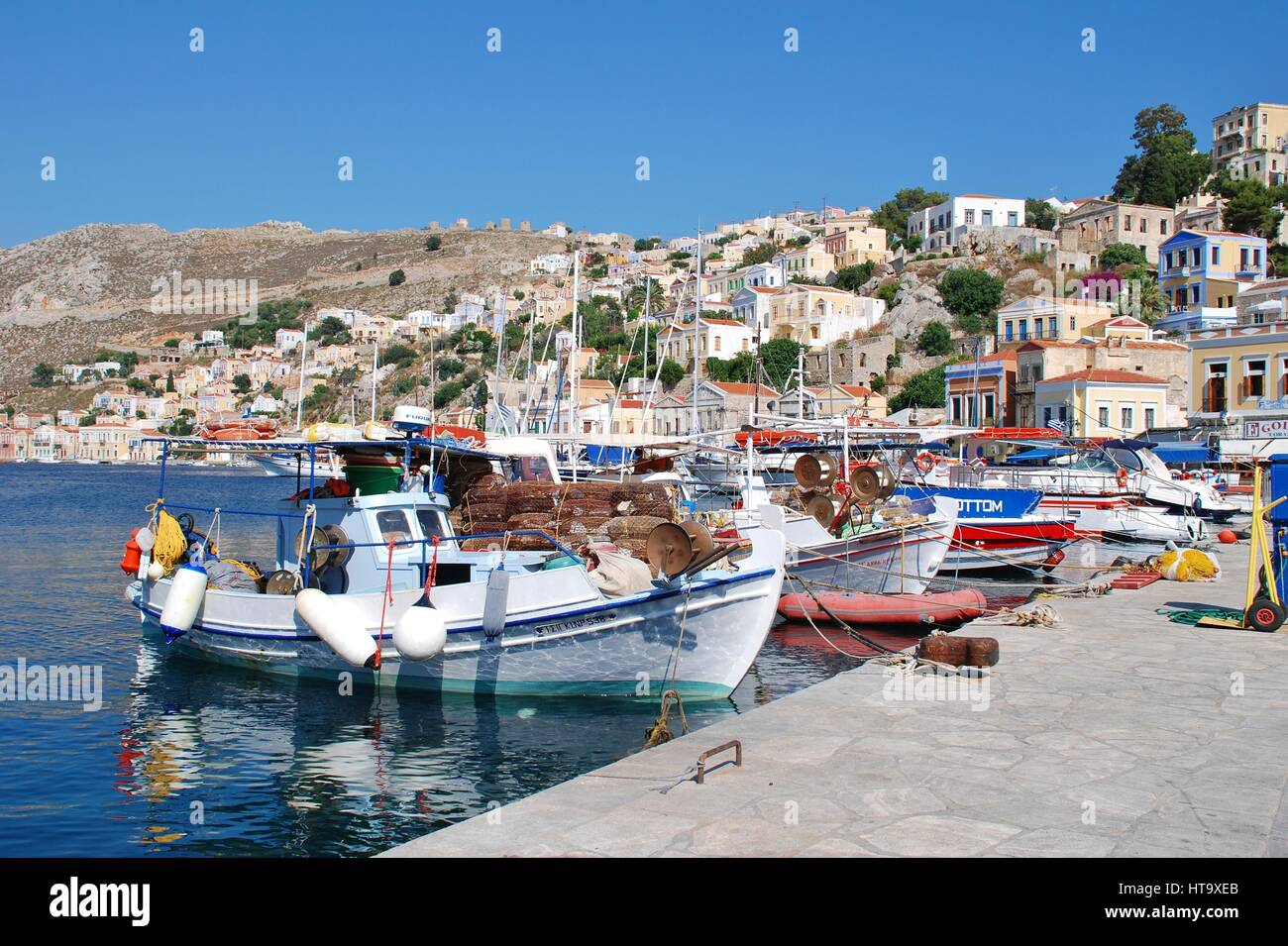 Small boats moored in Yialos harbour on the Greek island of Symi. Stock Photo