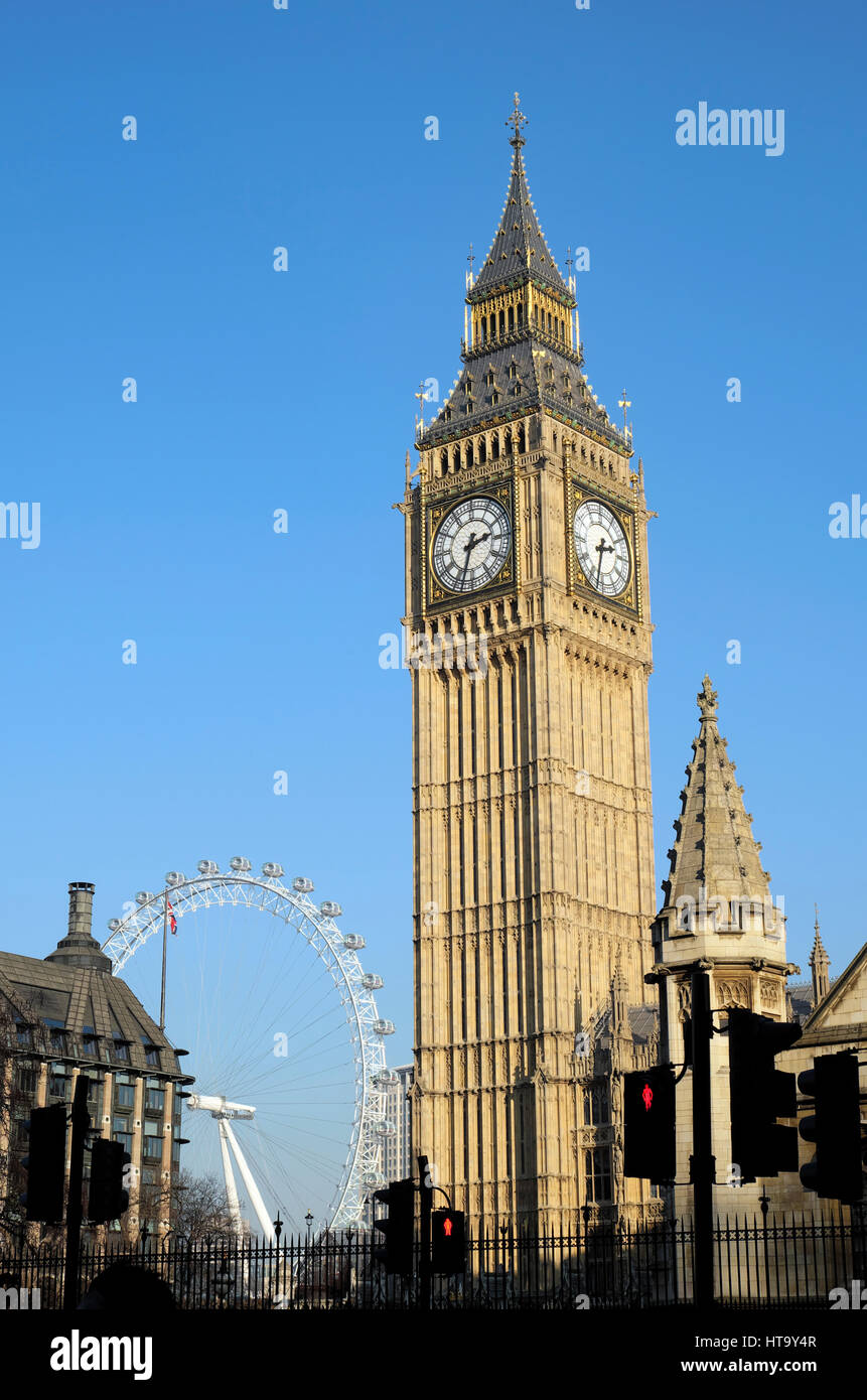 Vertical view of Big Ben clock tower blue sky and the London Eye with blue sky in winter Westminster, London, UK  KATHY DEWITT Stock Photo