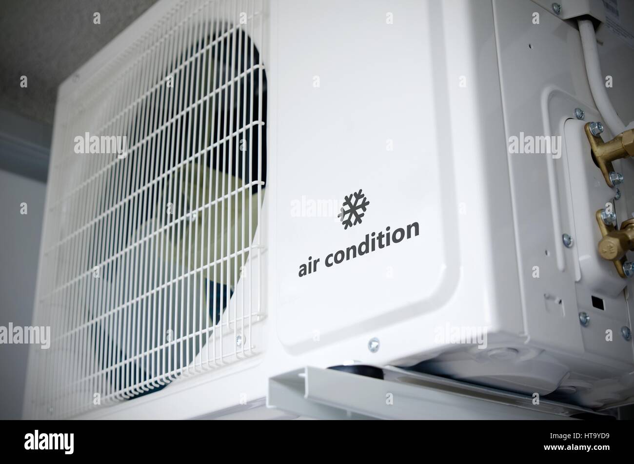 Air conditioning compressor installation outside building with sample logo with snowflake Stock Photo