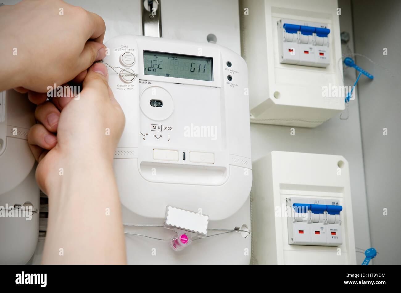 Electric energy meter. Electrical technician servicing unit Stock Photo