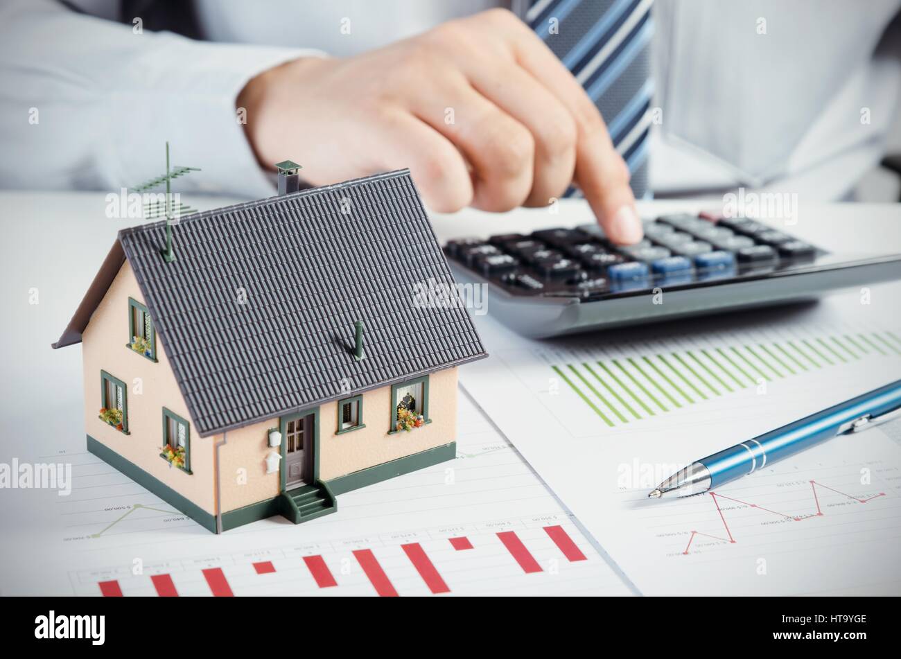 Businessman calculate the cost of building and maintaining house. Home