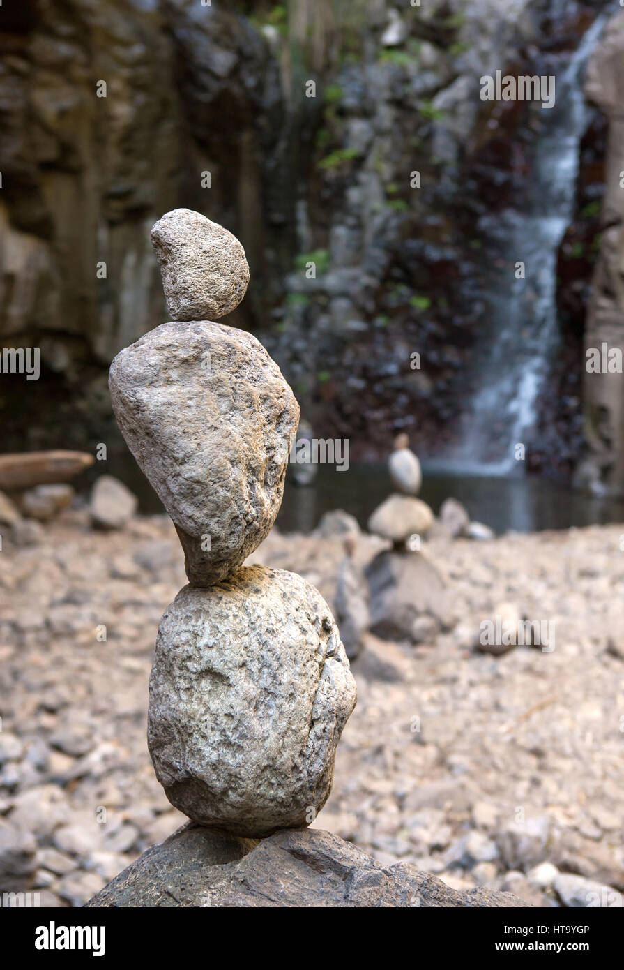 Stones in balance in front of a waterfall Stock Photo