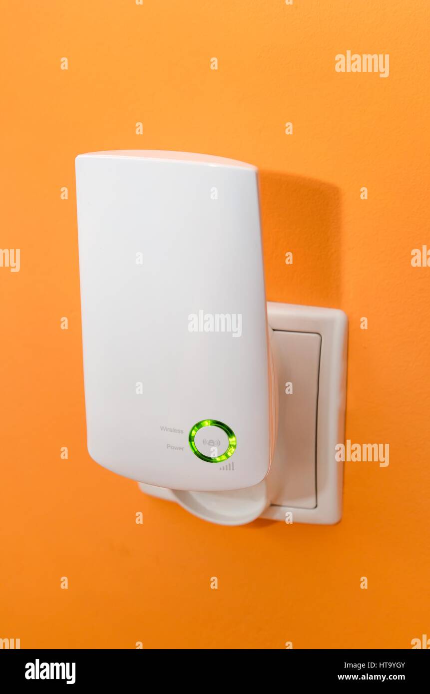 WiFi repeater in electrical socket on orange wall. Simply way to extend  wireless network in home Stock Photo - Alamy