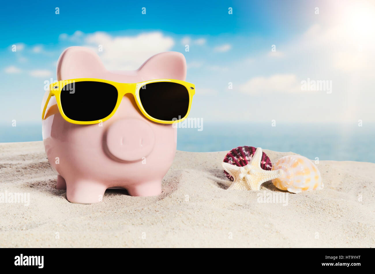 Piggy bank with sunglasses on vacation. Concept of holidays economy Stock Photo