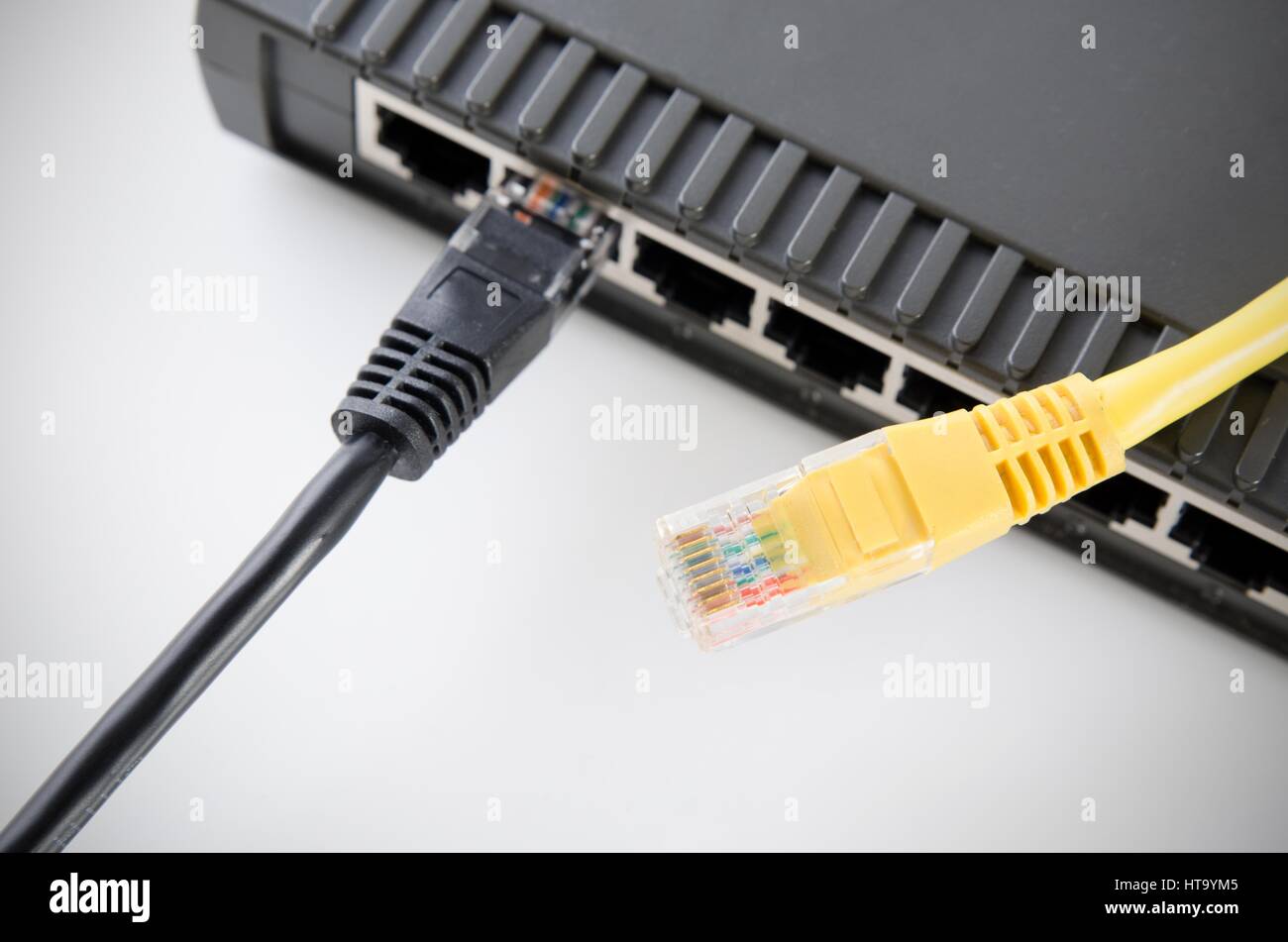 Network switch device and ethernet cables on white background Stock Photo