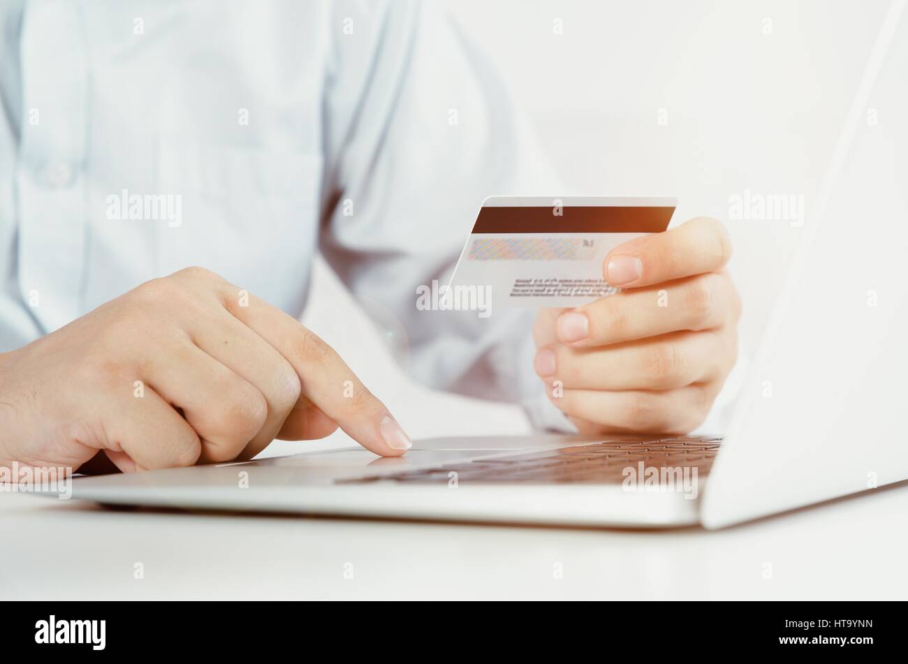 Man with laptop using credit card. Internet shopping concept. Stock Photo