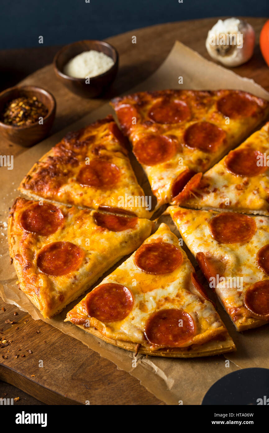 Cheap Greasy Frozen Pepperoni Pizza Ready to Eat Stock Photo Alamy