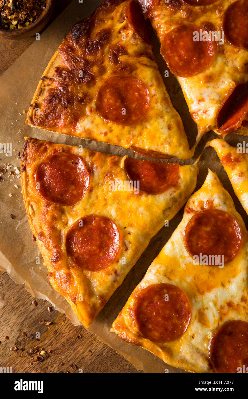 Cheap Greasy Frozen Pepperoni Pizza Ready to Eat Stock Photo Alamy