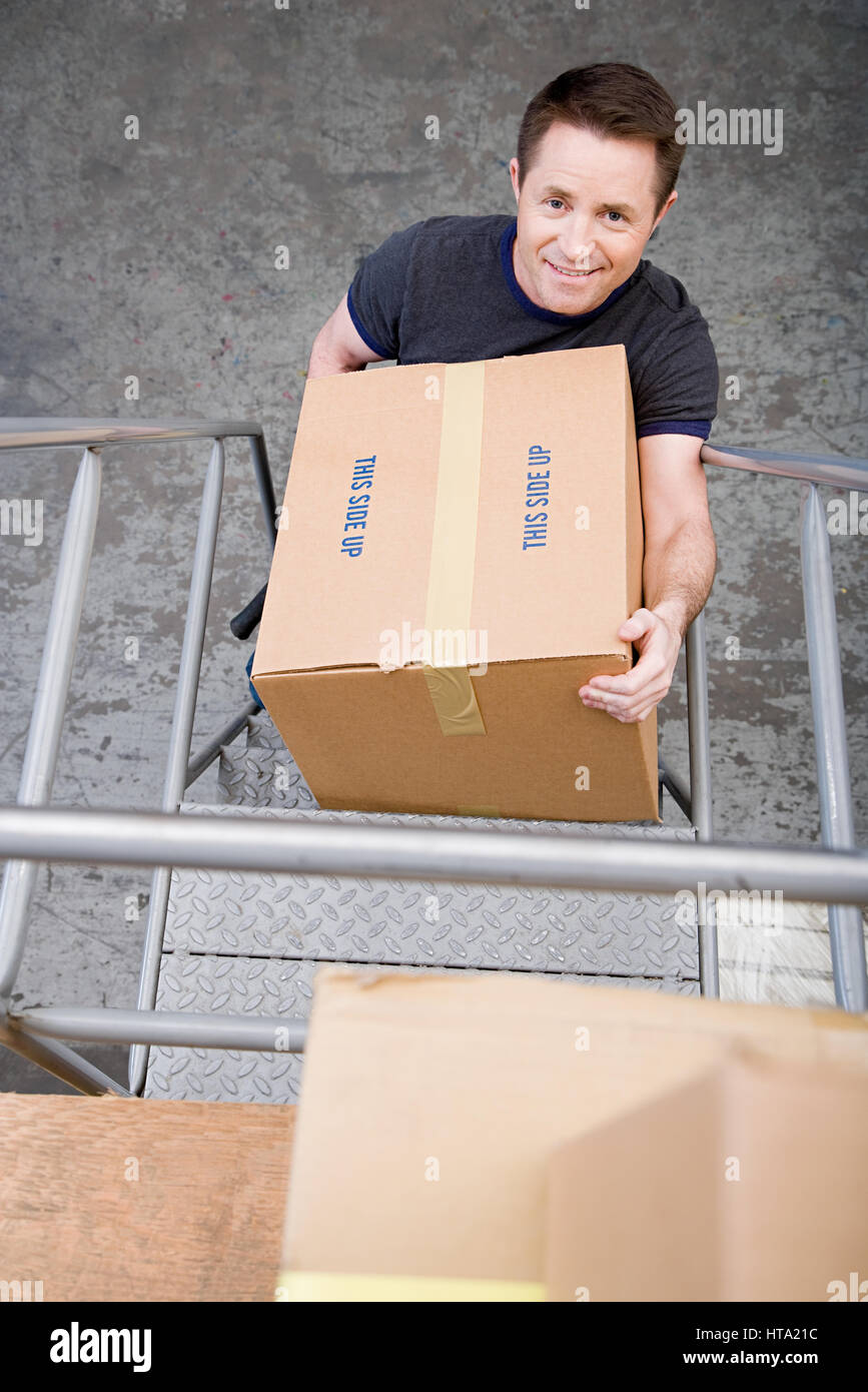 Man carrying a box Stock Photo