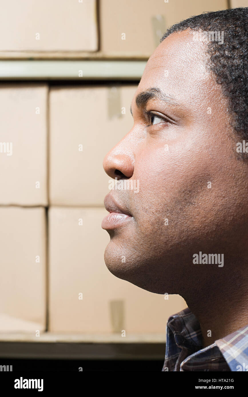 Man in front of cardboard boxes Stock Photo