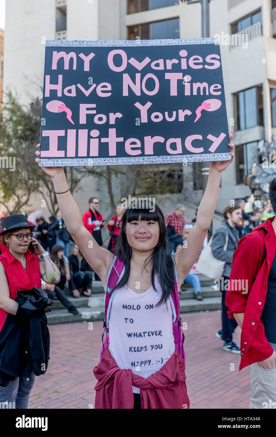 San Francisco, USA. 8th Mar, 2017. A woman holds a protest sign reading, 'My ovaries have no time for your illiteracy' at the San Francisco International Women's Day rally just before the march from Justin Herman Plaza. Credit: Shelly Rivoli/Alamy Live News Stock Photo