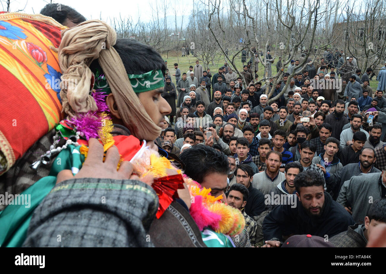 Srinagar, Kashmir. 9th Mar, 2017. Kashmiri villagers take pictures of the body of a 15-year-old civilian Amir Nazir. during his funeral, Two militants and Two civilians killed in the encounter in Padgampora area of Jammu and Kashmir’s Pulwama district. This is the first civilian casualty since Army chief General Bipin Rawat warned civilians to stay away from encounter sites, saying those involved in stone-pelting on forces during gun battles with militants will not be dealt differently. Credit: sofi suhail/Alamy Live News Stock Photo