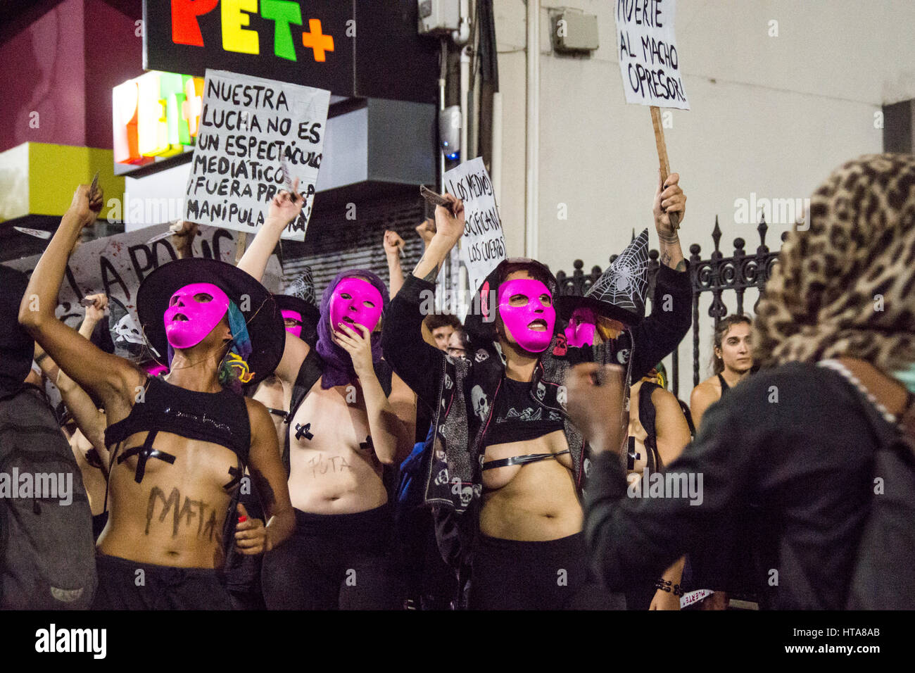 Women with masks marching with sings about women's day. Stock Photo
