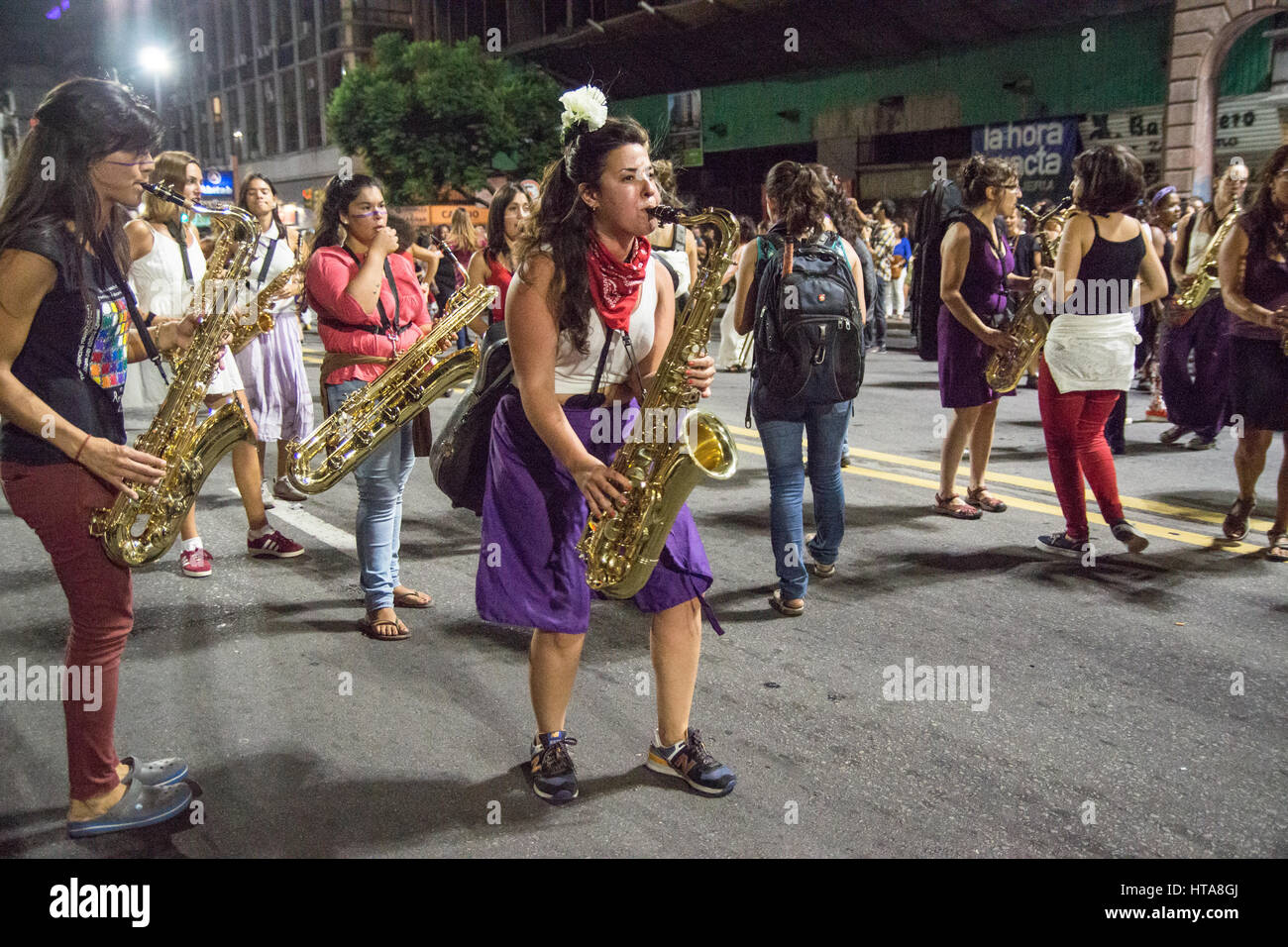 Women with saxo marching at women's day in main street of Montevideo, Uruguay. Stock Photo