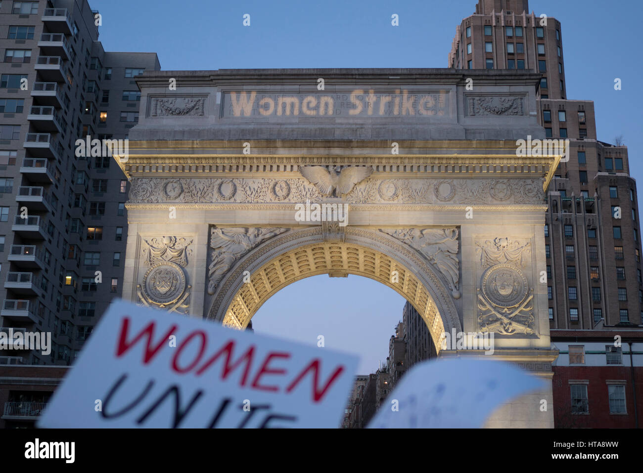 New York City, USA. 8th March 2017. “Women Strike!” being projected onto the Washing Square Arch during the International Working Women’s Day Strike rally in NYC. Credit: Sinisa Kukic/Alamy Live News Stock Photo