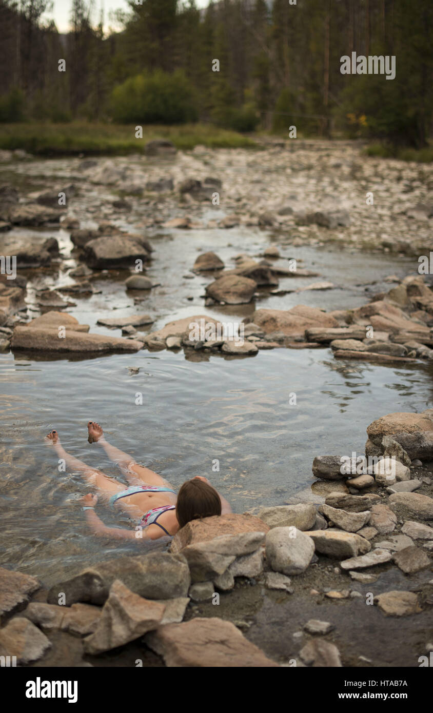 July 30, 2013 Idaho, USA Hot spring session with bikini and board