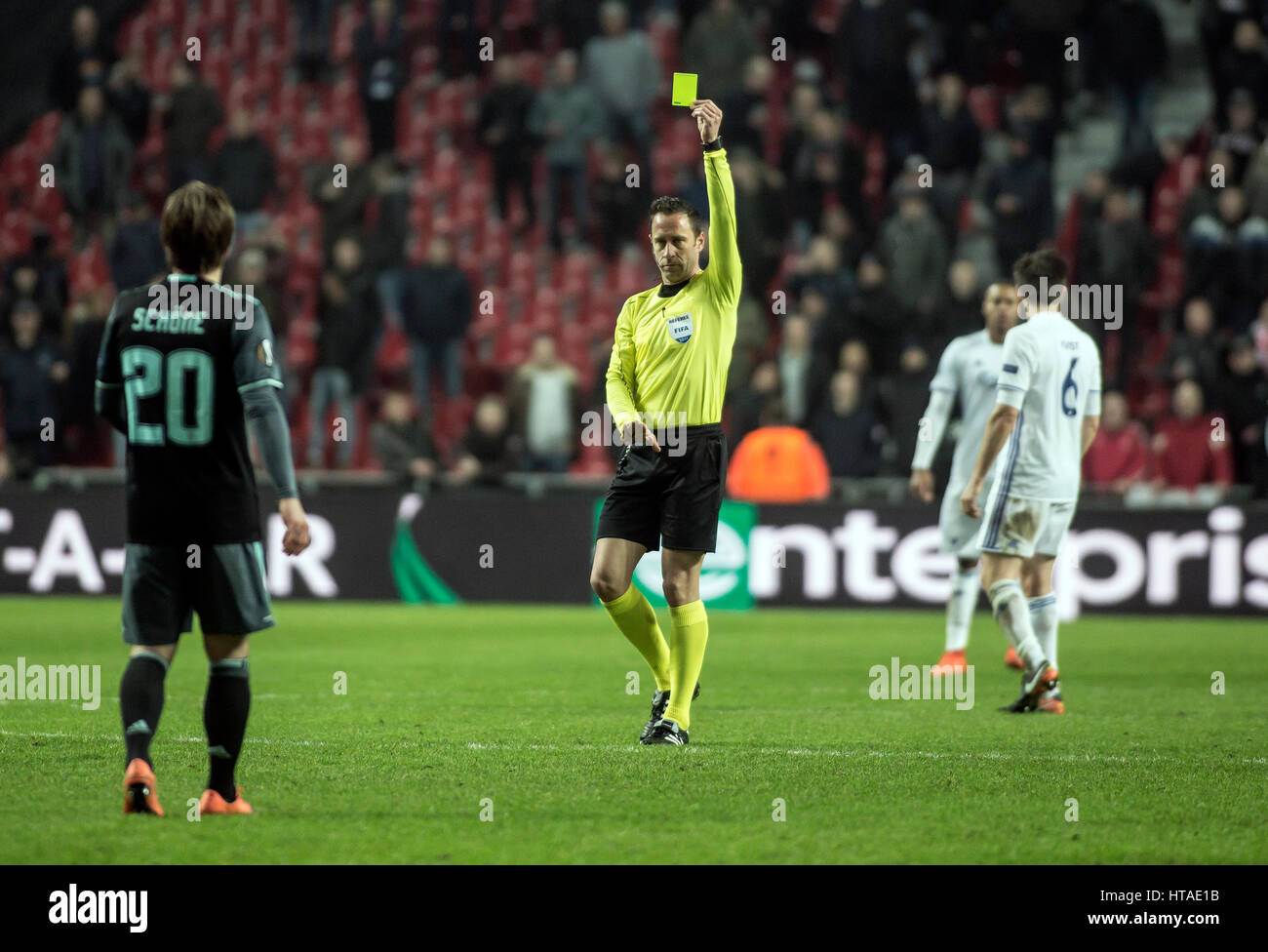 Denmark, Copenhagen, March 9th 2017. Portuguese referee Artur Soares hands out a yellow card to Ajax's Lasse Schøne (20) during the Europa League round of 16 match between FC Copenhagen and Ajax Amsterdam at Telia Parken. Stock Photo