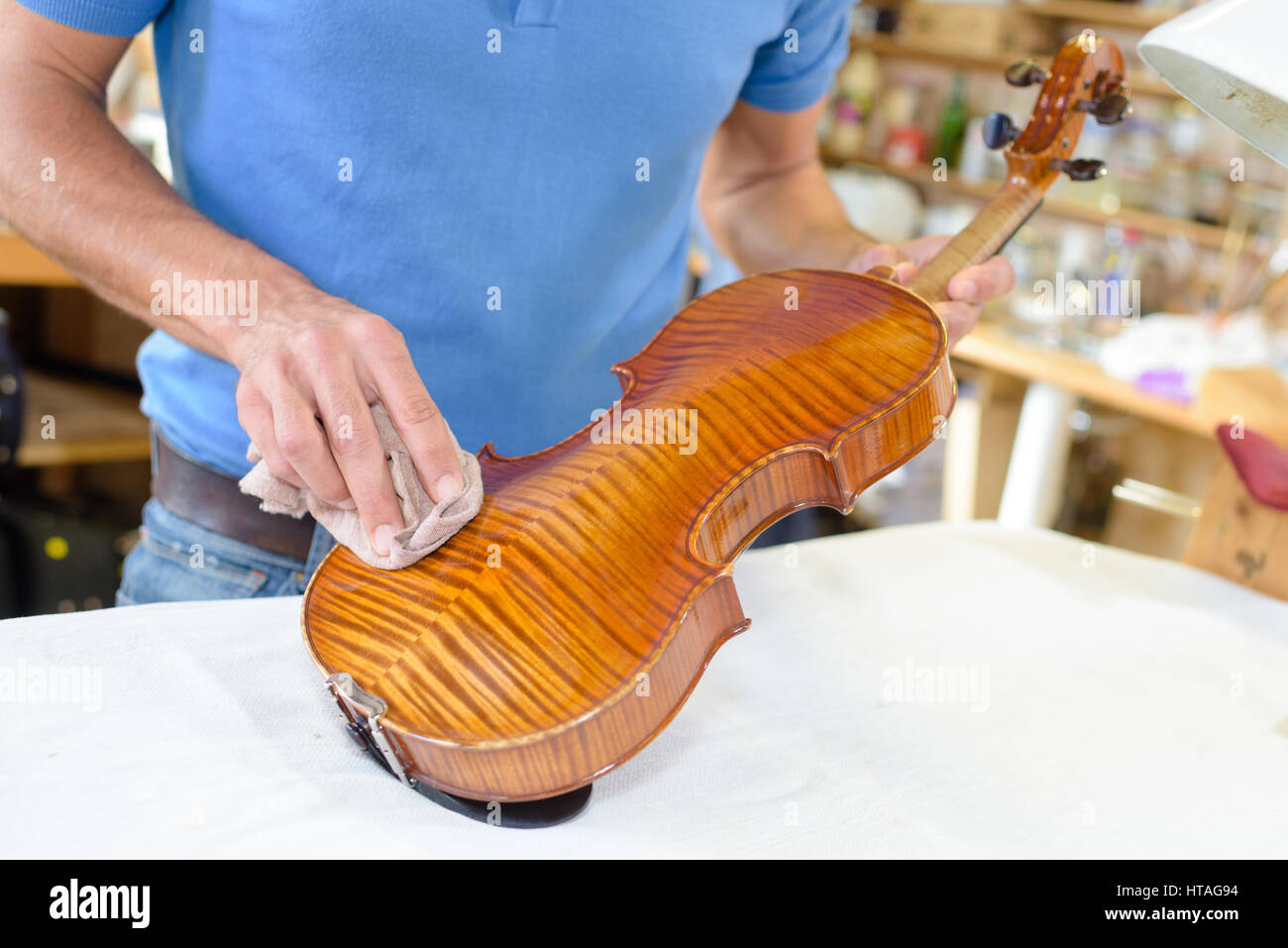Man polishing back of a violin Stock Photo Alamy