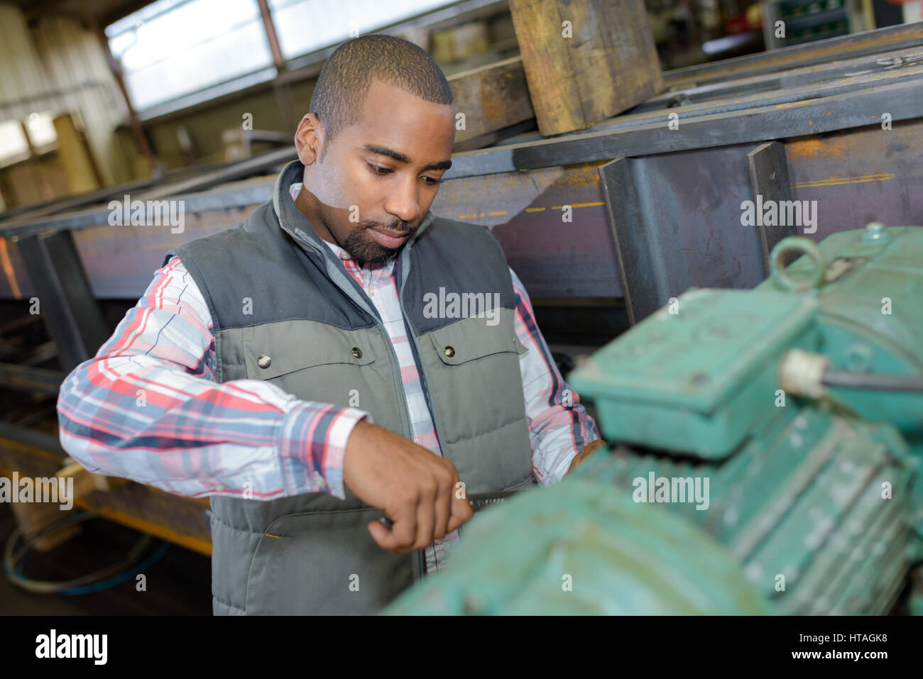 worker fixing a machine motor Stock Photo
