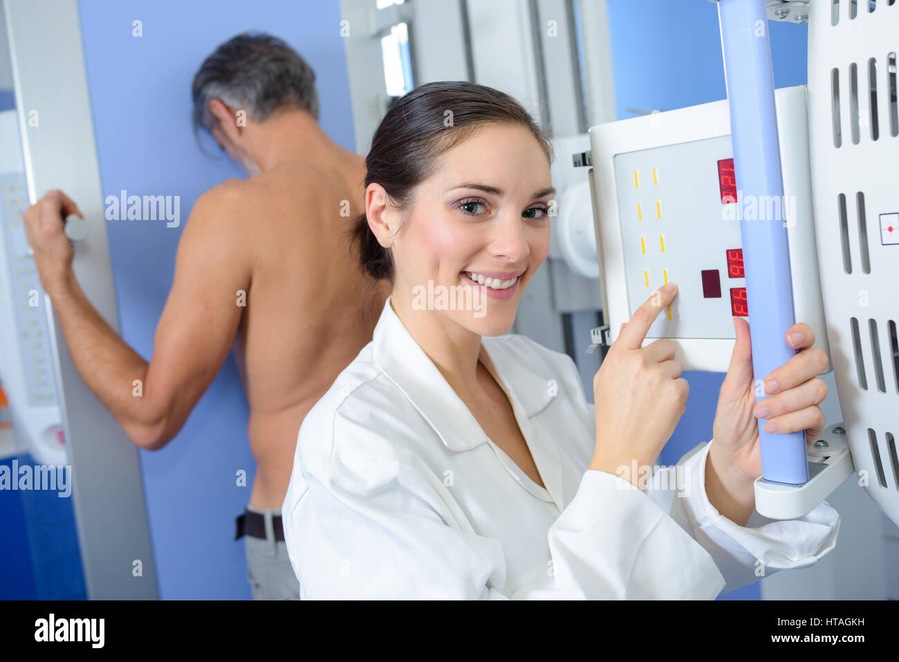 Nurse preparing equipment to xray man Stock Photo