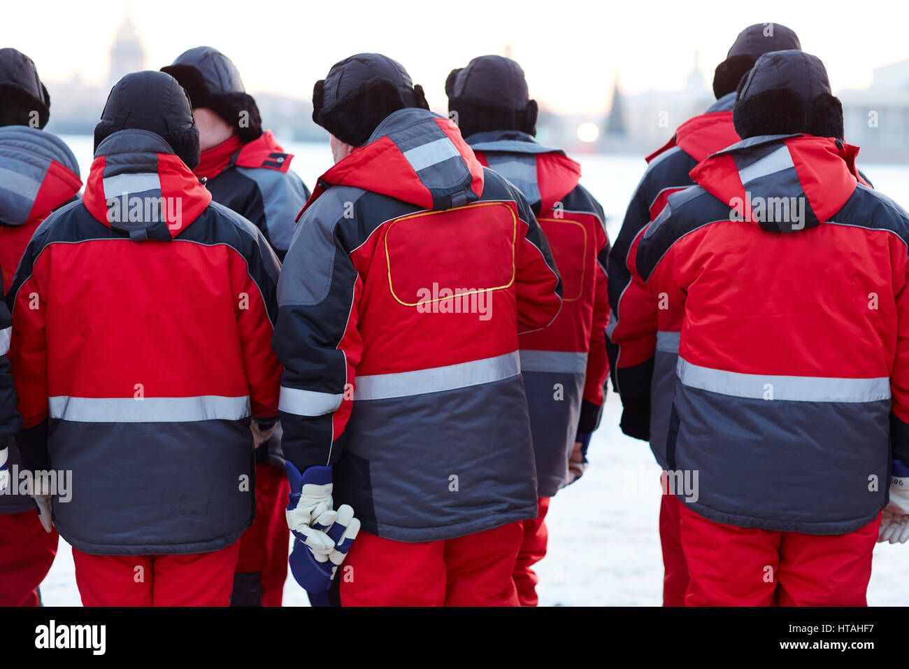 Humans in special uniform standing in two rows ready for emergency