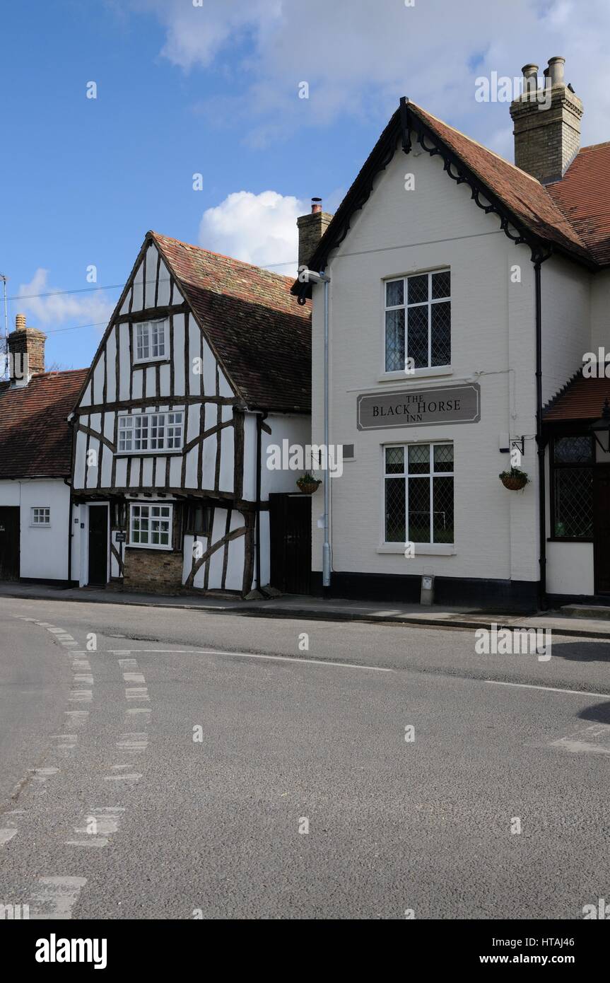 The Black Horse inn which proclaims on its walls ‘Drink – Eat - Sleep’ and Bolbec Cottage which  is dated 1587, Swaffham Bulbeck, Cambridgeshire Stock Photo