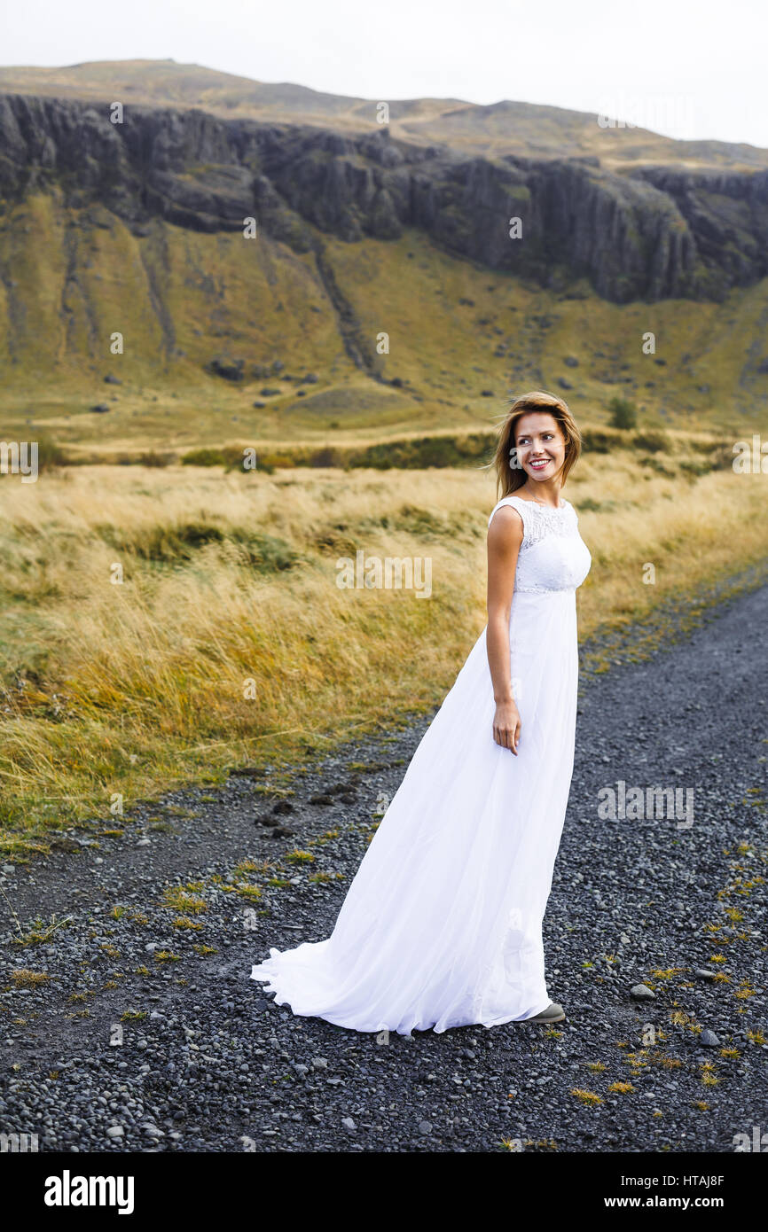 Happy young bride in white gown during honeymoon journey Stock Photo